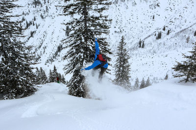 Man snowboarding on snowcapped mountain