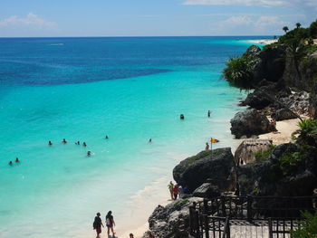 People on beach against sky