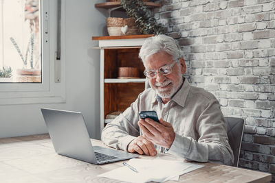 Friends using laptop at home