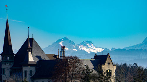 Houses and buildings against sky during winter