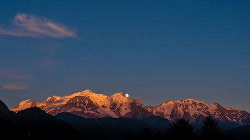 Scenic view of mountains against cloudy sky