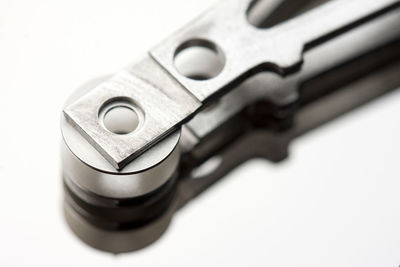 Close-up of camera on table against white background