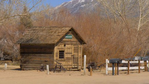 View of wooden house and trees on landscape