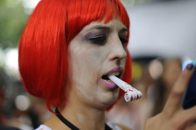 Close-up of woman with party horn blower