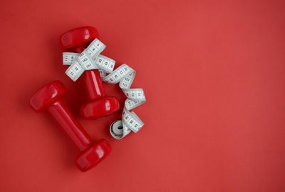 High angle view of dumbbells on yellow background