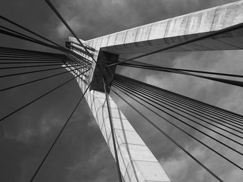 Low angle view of suspension bridge against sky