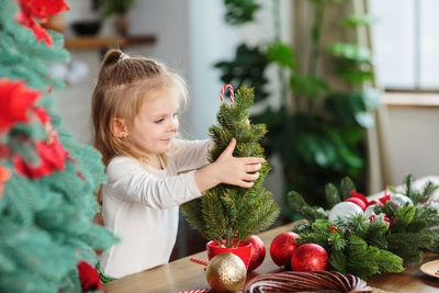 Portrait of cute girl decorating christmas tree