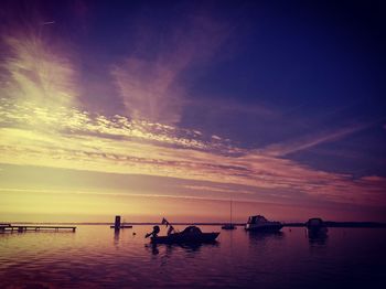 Scenic view of sea against dramatic sky during sunset