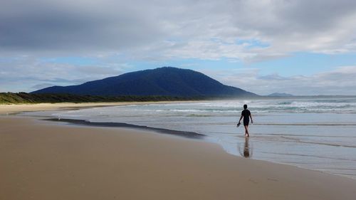 Man on beach against sky