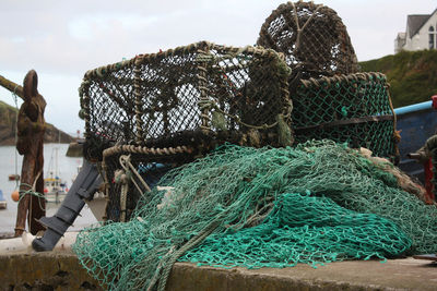 Fishing nets and crab pots piled on wharf