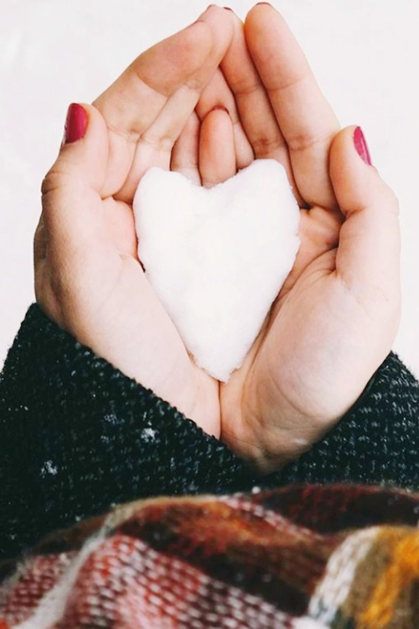 CLOSE-UP OF HAND HOLDING HEART SHAPE IN WINTER