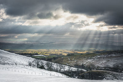 Scenic view of landscape against sky during winter