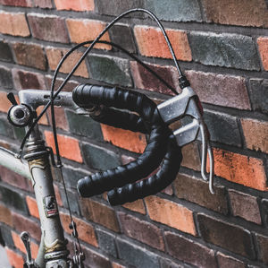 Low angle view of old metal against wall