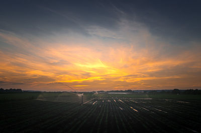 Scenic view of field against sky during sunset