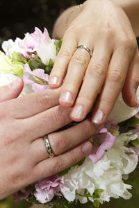 Cropped hands of woman holding bouquet