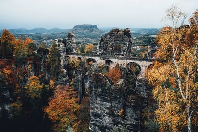 View of old ruins and trees against sky