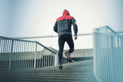 Rear view of man running on steps