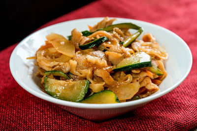 Close-up of pasta with in bowl on table against black background