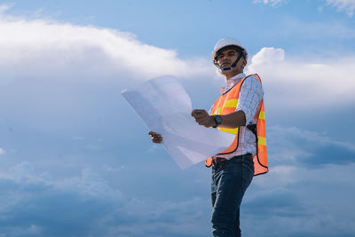 Low angle view of man standing against sky