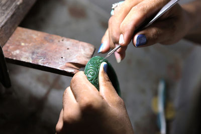 Cropped hands of person working on decoration