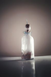 Close-up of bottle on table against white background