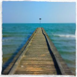 Wooden jetty leading to sea