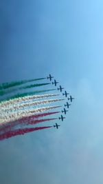 Low angle view of airplane flying against sky