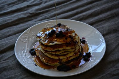 Close-up of pancakes in plate on table