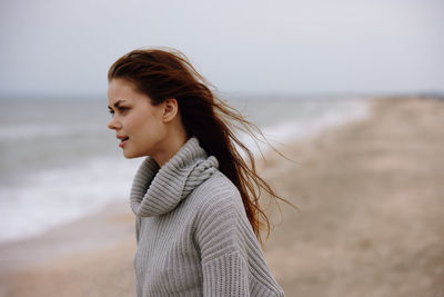 Young woman standing at beach