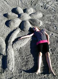 Full length of woman standing on sand