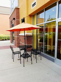 Empty chairs and table outside building