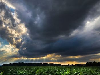 Scenic view of dramatic sky over land