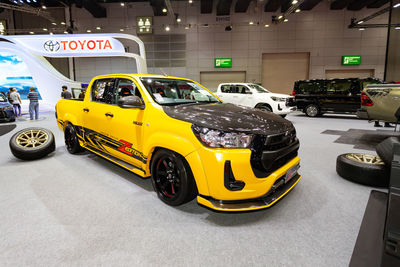 Yellow toy car on road in city