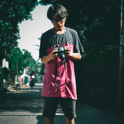 Portrait of teenage girl photographing