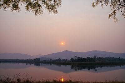 Scenic view of lake against sky during sunset