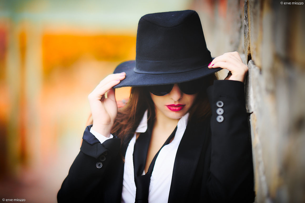 adult, clothing, fedora, hat, one person, fashion, women, portrait, fashion accessory, young adult, sun hat, black, elegance, spring, female, business, person, front view, formal wear, lifestyles, jacket, arts culture and entertainment, city, outdoors, copy space, standing, cool attitude, emotion, headshot
