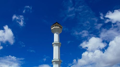 Low angle view of tower and building against sky