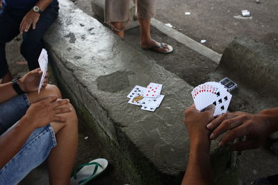 A group of men playing cards during their spare time.