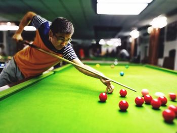 Close-up of man playing pool