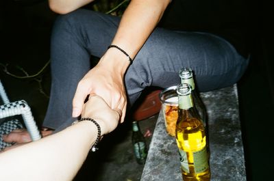 Low section of man and woman drinking glass