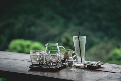 Close-up of empty drinking glasses on table outdoors