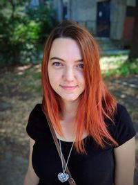 Portrait of redhead young woman in city