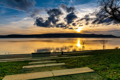 Scenic view of lake against sky during sunset