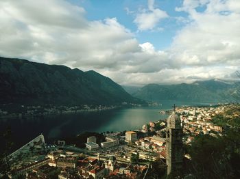 High angle view of townscape by sea against sky