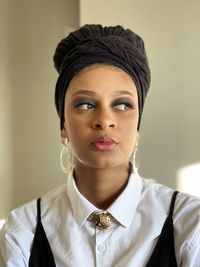 Portrait of a beautiful young black woman looking away from the camera 