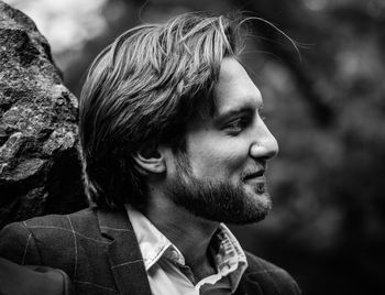 Profile view of young man looking away outdoors