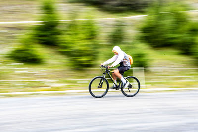 Man riding bicycle on road