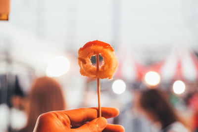 Close-up of hand holding orange