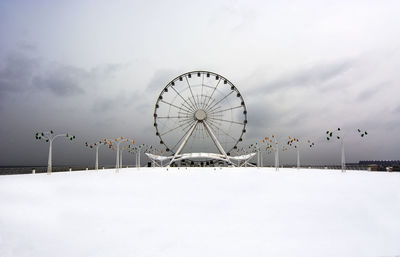 Ferris wheel against sky during winter
