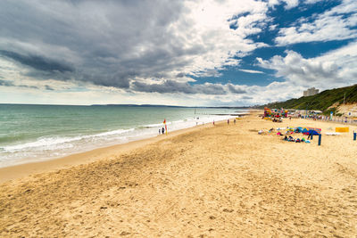 People on beach against sky